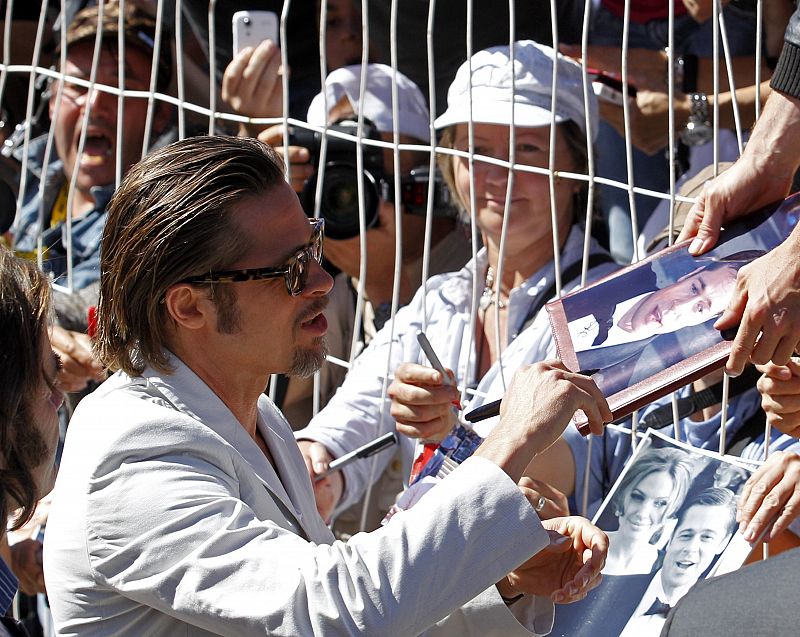 Actor Brad Pitt signs autographs before a photocall for the film 'The Tree of Life' by director Terrence Malick, in competition at the 64th Cannes Film Festival