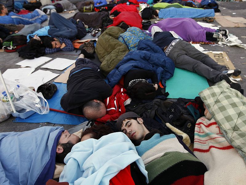 Demonstrators camp out in Madrid's Puerta del Sol during seventh day of protests