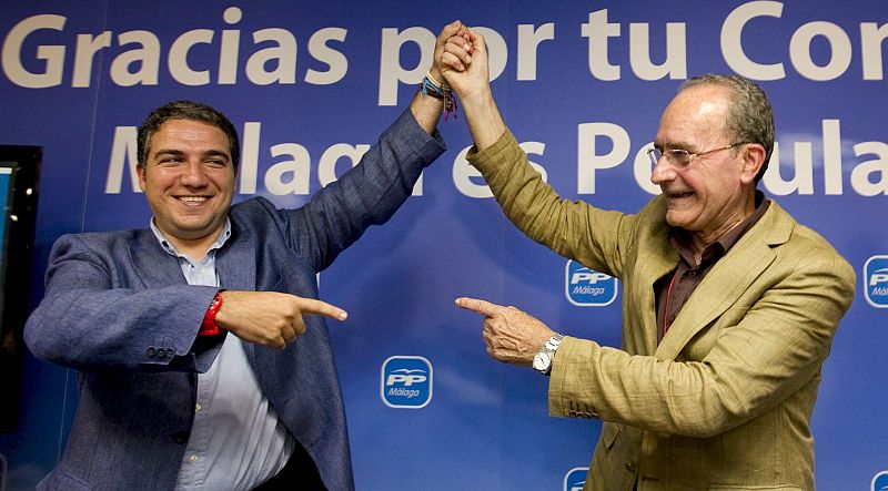 El alcalde de Málaga, Francisco de la Torre (d), y el presidente provincial del PP, Elías Bendodo, saludan tras la victoria conseguida en las elecciones municipales hoy en la capital malagueña.