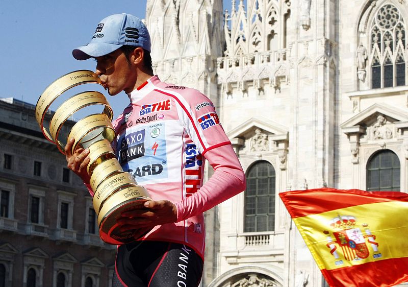 Alberto Contador besando el trofeo de vencedor del Giro 2011 en el podio de Milan.