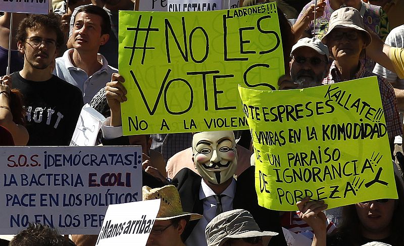 Demonstrators holding banners march towards Spanish parliament in Madrid