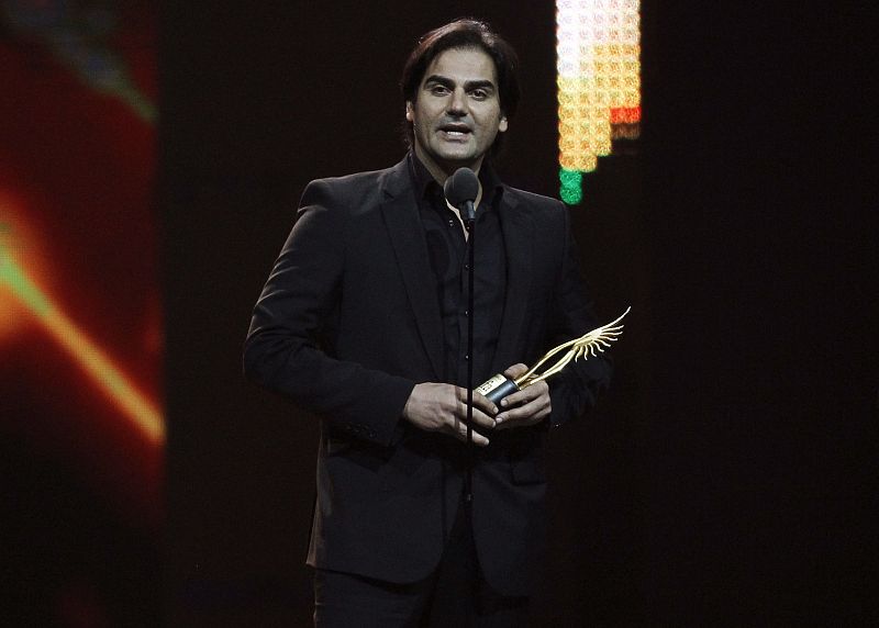 Khan accepts his award for best picture for his work in "Dabangg during the IIFA awards show in Toronto