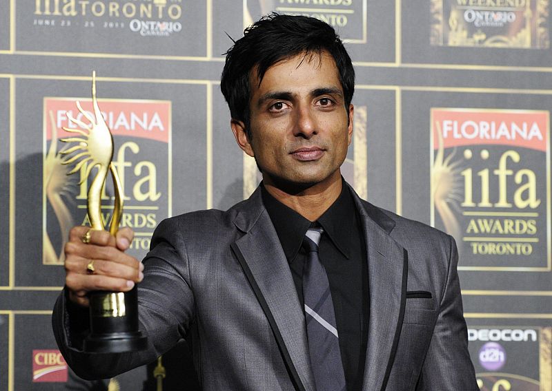 Bollywood actor Sonu Sood hold his award for best performance in a negative role for his work in "Dabangg" during The International Indian Film Academy (IIFA) Awards in Toronto