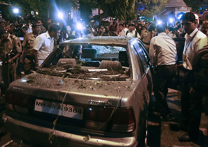 Un grupo de policías rodea un vehículo dañado en uno de los lugares de las explosiones