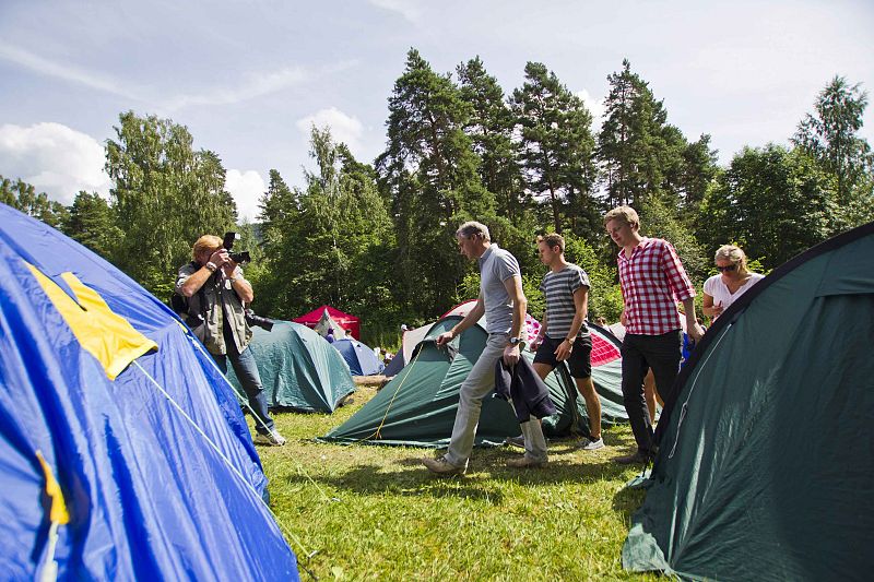 Norway's Foreign Minister Jonas Gahr Stoere walks during his visit to a youth summer camp in Utoeya island