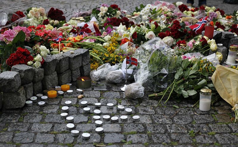 Flowers and candles are placed on the market square outside the Oslo cathedral to mourn the victims of a bomb blast and a rampage