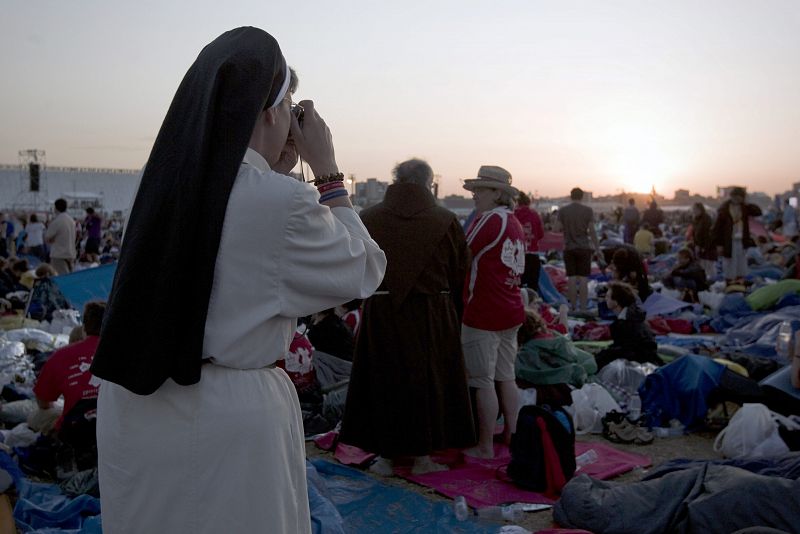 Una religiosa hace una fotografía a los numerosos jóvenes y peregrinos que se encuentran en el aeródromo de Cuatro Vientos