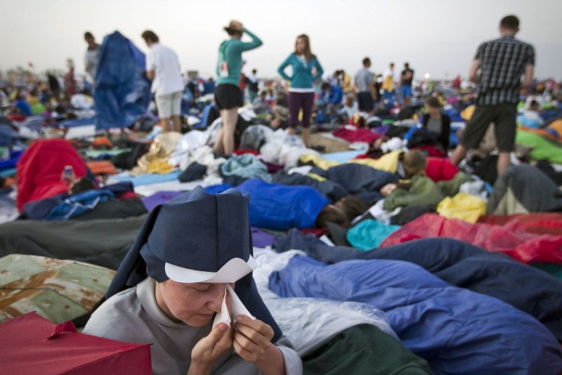 Una religiosa entre un grupo de peregrinos durante el amanecer en el aeródromo de Cuatro Vientos