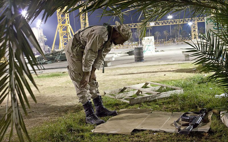 Un soldado rebelde reza en la Plaza Verde de Trípoli