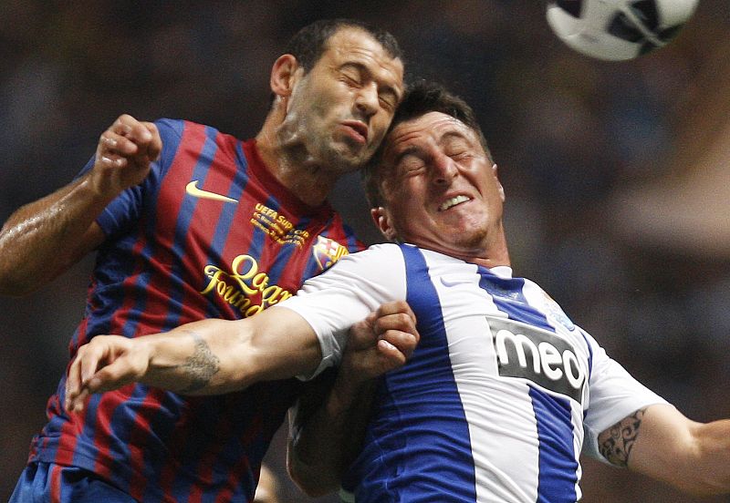 Porto's Rodriguez and Barcelona's Javier Mascherano fight for the ball during their European Super Cup soccer match at Louis II stadium in Monaco