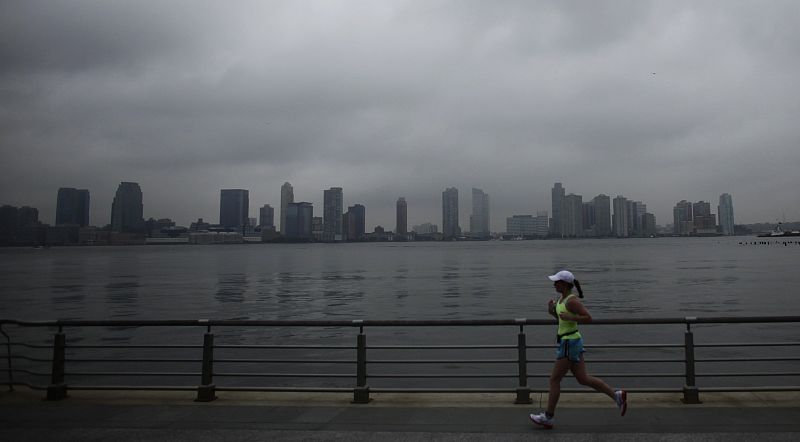 A woman jogs before the arrival of Hurricane Irene at downtown Manhattan in New York