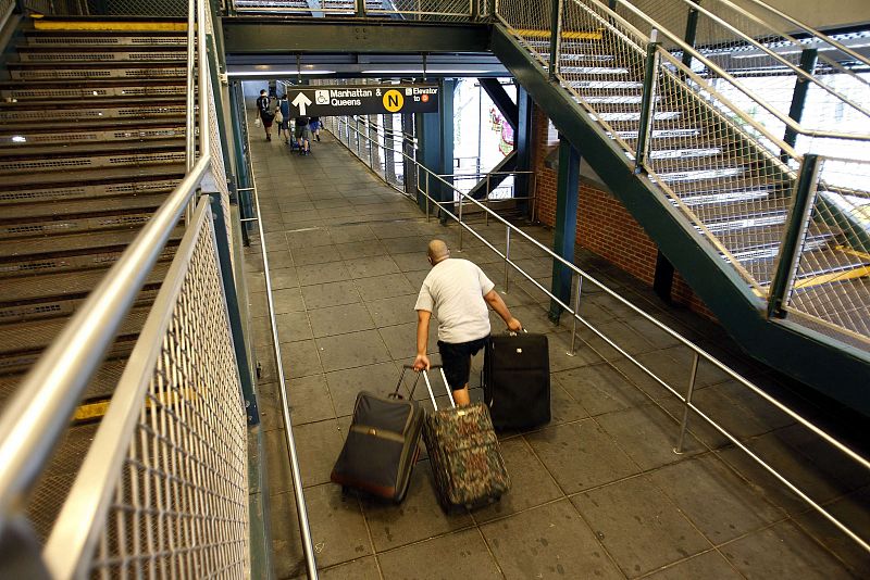 A man walks up the ramp to the subway to catch the last train out ahead of Hurricane Irene's arrival in New York