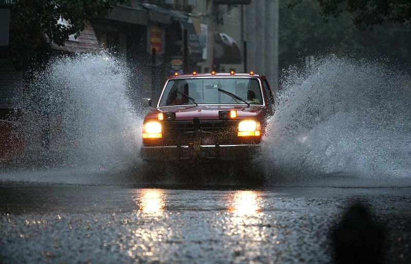 A car drives through a flooded street in Hoboken, New Jersey