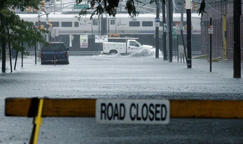 A car drives through a flooded street in Hoboken, New Jersey