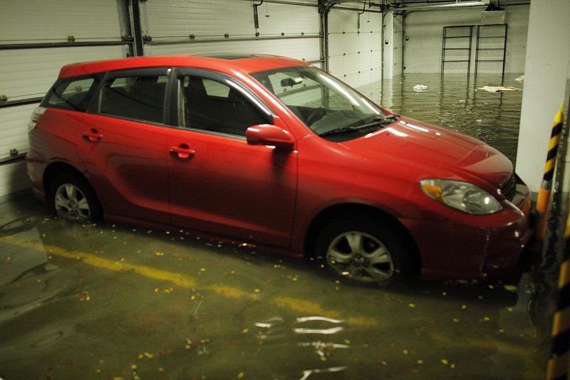 Car is seen in a flooded parking in Hoboken