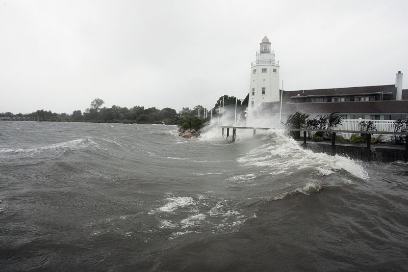 A lighthouse-shaped building is battered by storm surge and winds from Hurricane Irene in Montauk, New York