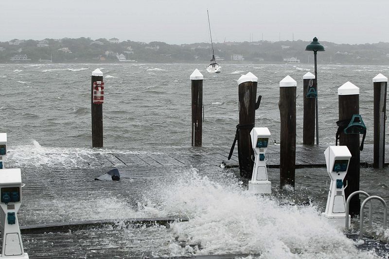 A board torn out of a dock lies on the dock as it is overwhelmed by storm surge and winds from Hurricane Irene in Montauk, New York