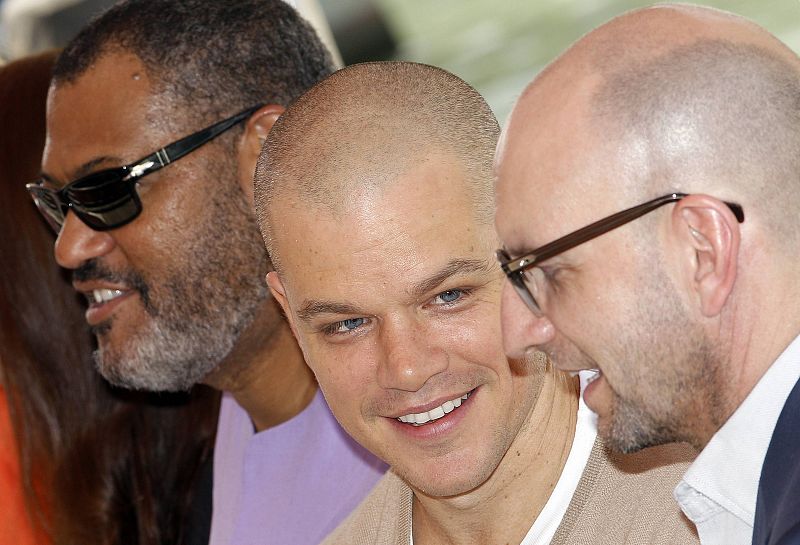 U.S. actor Damon is flanked by Soderbergh, director of movie "Contagion", and actor Fishburne,  as they arrive at the Film Cinema's Place in Venice