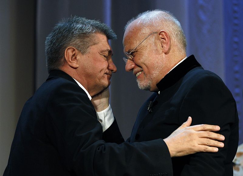 Sokurov, director of "Faust", is congratulated by director of the Venice Film festival Mueller at the 68th Venice Film Festival