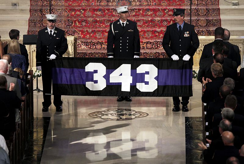 Firefighters carry banner with number 343, number of firefighters killed on 9/11, in St. Patrick's Cathedral, during a ceremony to honor New York firefighters that were killed in 9/11 attacks on World Trade Center, in New York