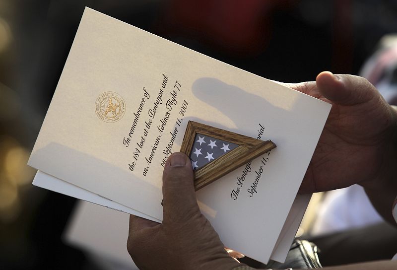 A guest holds the program for ceremonies in honor of the victims of the attack on the Pentagon during ceremonies marking the 10th anniversary of the 9/11 attacks on the Pentagon in Washington