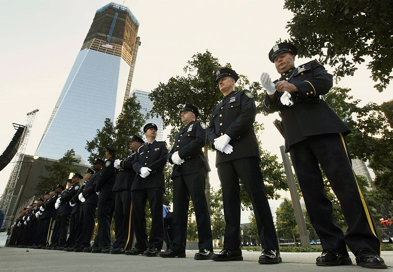 New York police, firefighters and Port Authority Police line up at one of the entrances of 9/11 Memorial Plaza before the tenth anniversary ceremonies at the World Trade Center site in New York