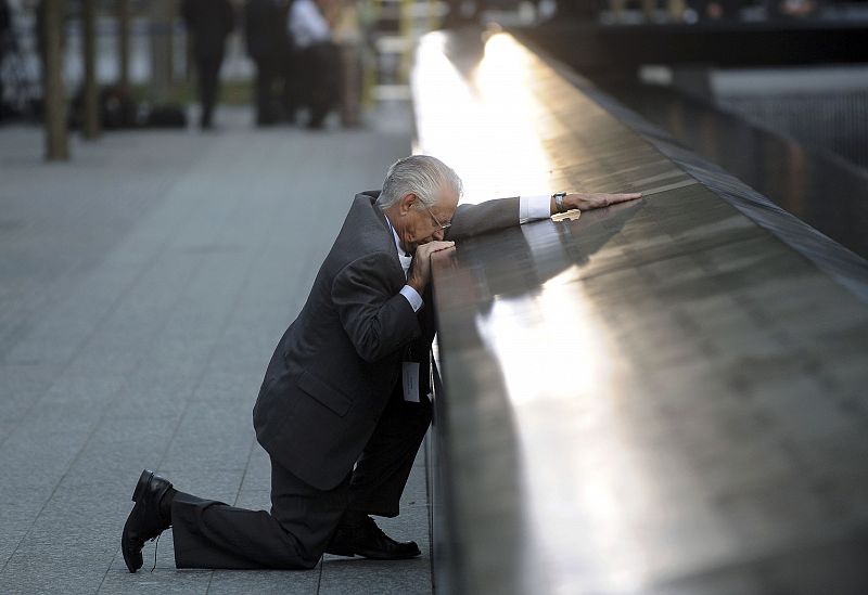 Robert Peraza, who lost his son Robert David Peraza, pauses at his son's name at the North Pool of the 9/11 Memorial during tenth anniversary ceremonies at the site of the World Trade Center in New York