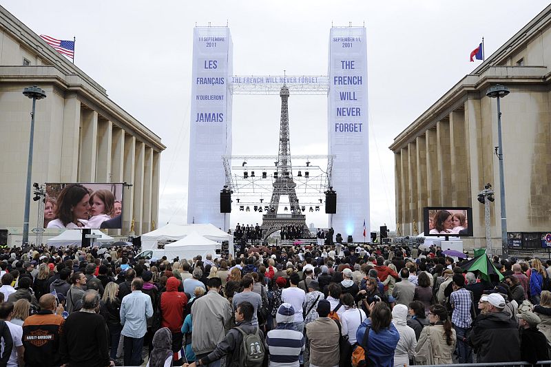 People observe a moment of silence during an event to mark the 10th anniversary of the 9/11 attacks on the World Trade Center, near the Eiffel Tower in Paris