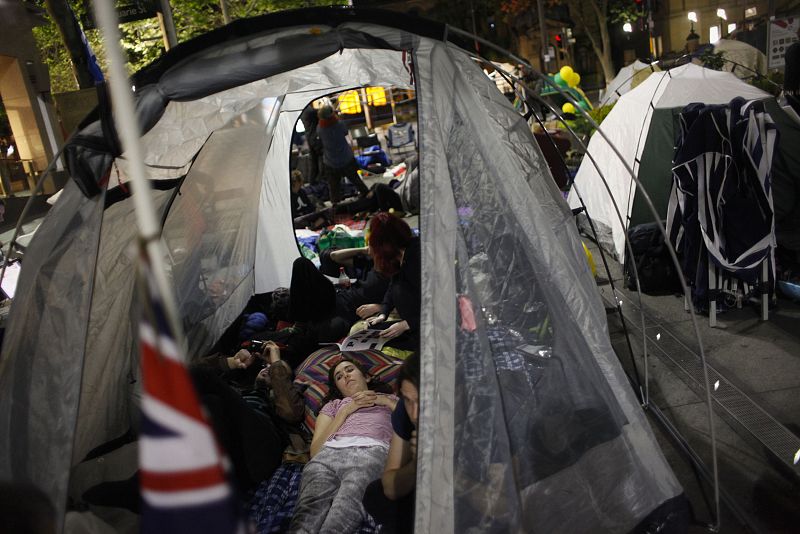 Protesters of the "Occupy Sydney" movement lie in their tents in front of the Reserve Bank of Australia in central Sydney