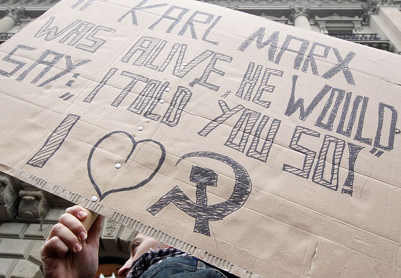 A demonstrator stands in front of the Credit Suisse building during the "Occupy Paradeplatz" protest in Zurich