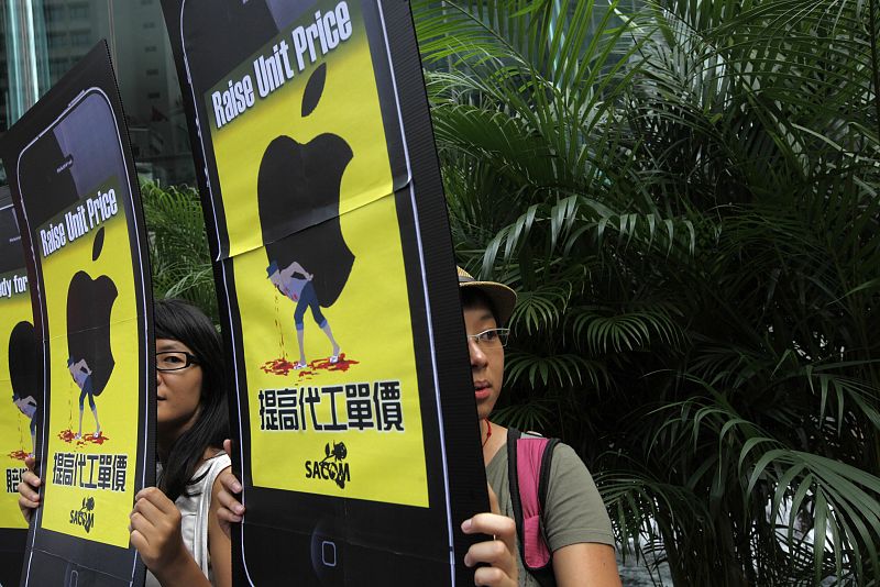 Labour activists hold cardboard cut outs resembling Apple iPhones during an "Occupy central" protest outside the Hong Kong Stock Exchange