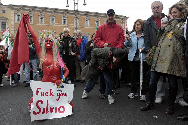 A Feman activist performs during a protest by PD party against Italian PM Berlusconi in Rome