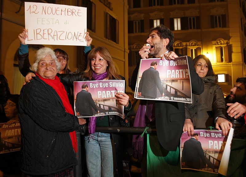 People hold placards depicting Italian Prime Minister Silvio Berlusconi outside Chigi palace in Rome