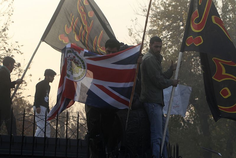 Los manifestantes arrancan la bandera británica y la sustituyen por la iraní.