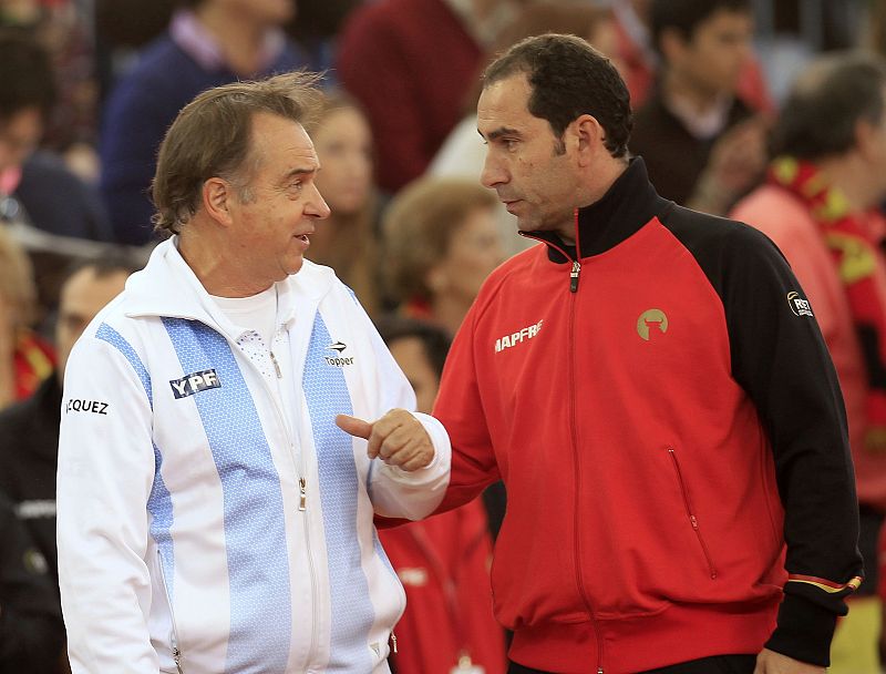 Argentina's team captain Vazquez and Spain's captain Costa talk before the Davis Cup final reverse singles rubber in Seville