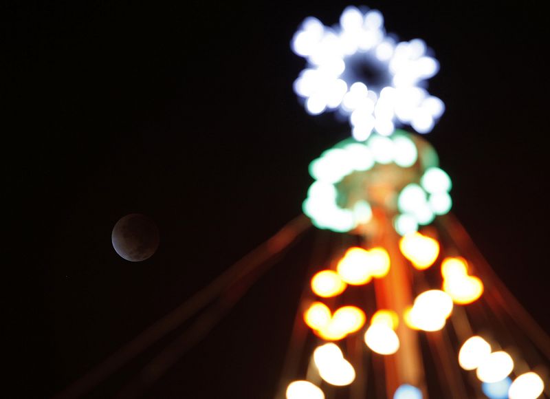 The lunar eclipse sets over the North Shore of Oahu in Haleiwa