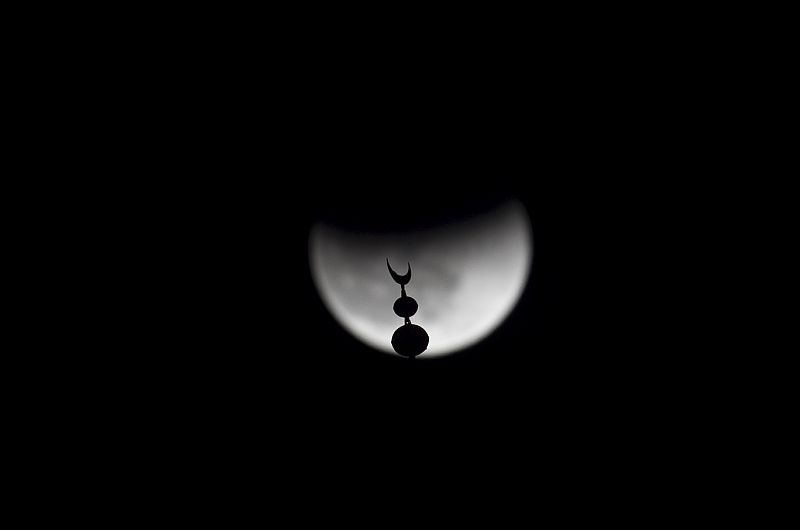 A total lunar eclipse is seen over the Tower of David in Jerusalem's Old City