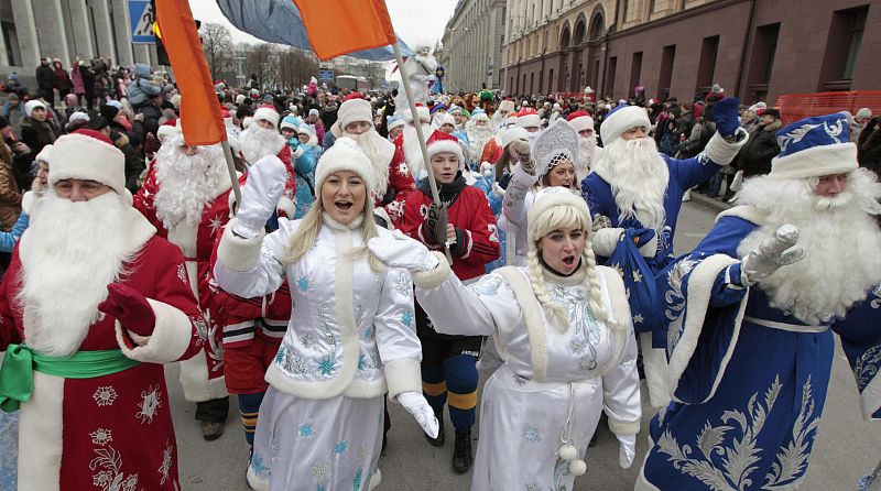 People dressed up as Father Frost, the equivalent of Santa Claus, and Snow Maiden, march in central Minsk