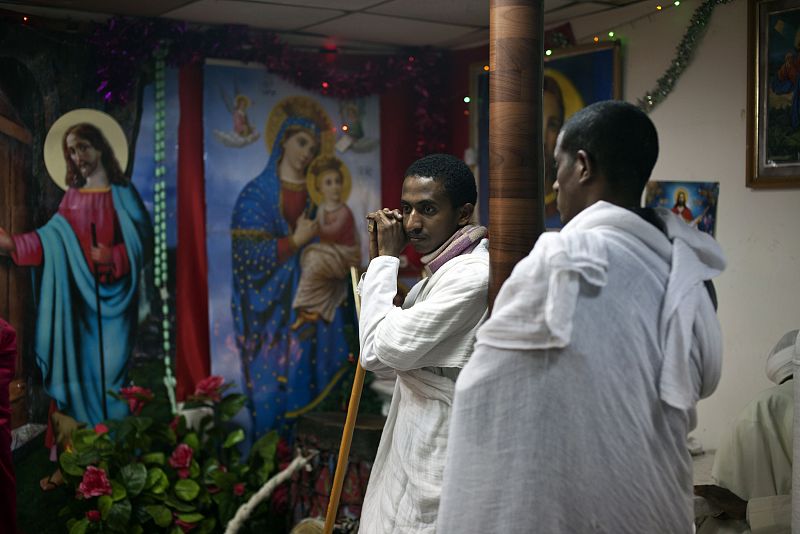 Eritrean asylum seekers attend a ceremony at their community's provisory church located in a flat in south Tel Aviv, ahead of Christmas