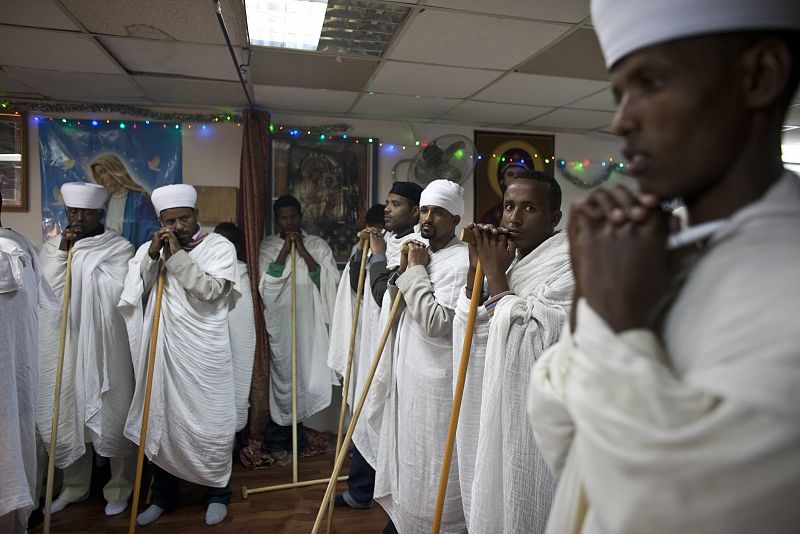 Eritrean asylum seekers attend a ceremony at their community's provisory church located in a flat in south Tel Aviv, ahead of Christmas