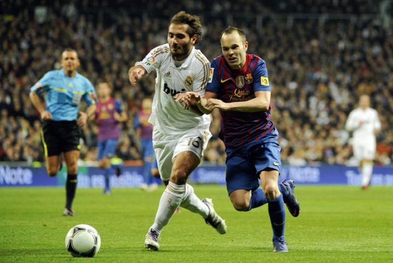  El jugador turco del Real Madrid, Hamit Altintop pelea con Iniesta.