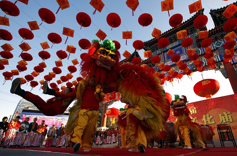 Performers take part in a lion dance during the opening of the temple fair at Ditan Park in Beijing