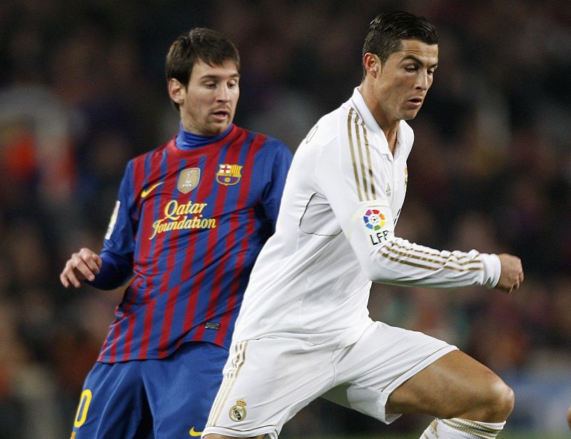 Barcelona's Messi and Real Madrid's Cristiano Ronaldo challenge during their Spanish King's Cup quarter-final soccer match in Barcelona