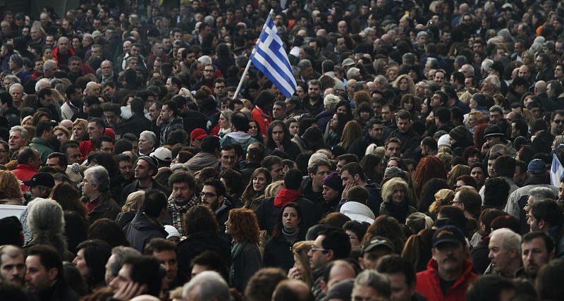 A Greek flag is waved while people take part in an anti-austerity demonstration in Athens