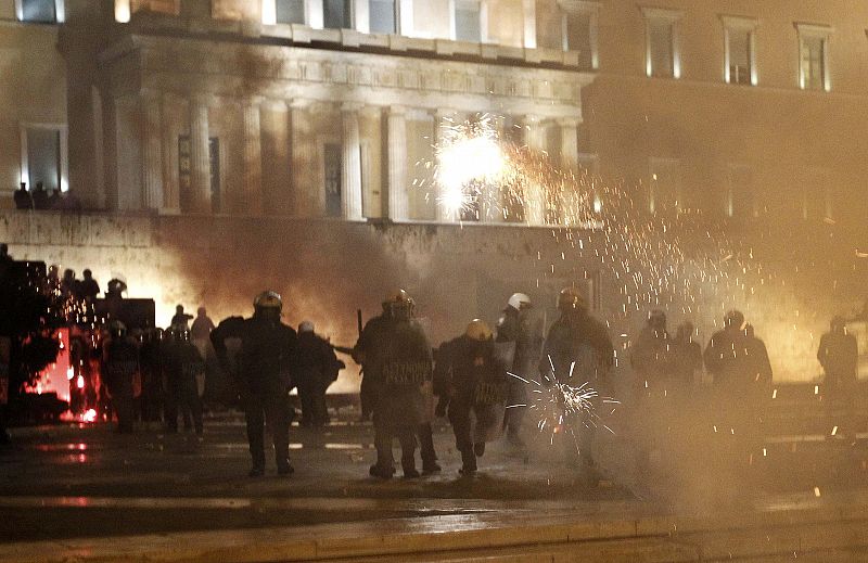 Fireworks and projectiles are aimed at the Greek parliament during violent anti-austerity protests in Athens' Syntagma in Athens