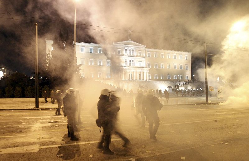 Smoke engulfs rioot police during violent protests in Athens