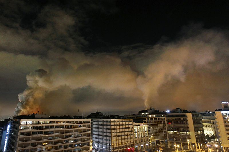 Vista panorámica de edificios ardiendo alrededor de la plaza Syntagma en Atenas in central Athens