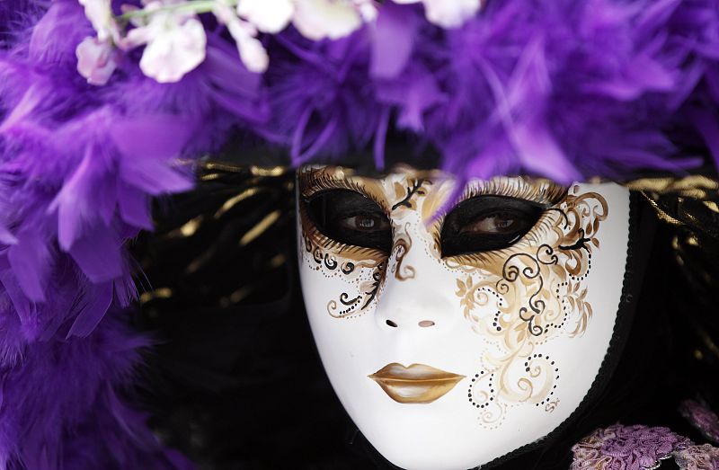 A masked reveller poses in Saint Mark's Square during the Venetian Carnival in Venice