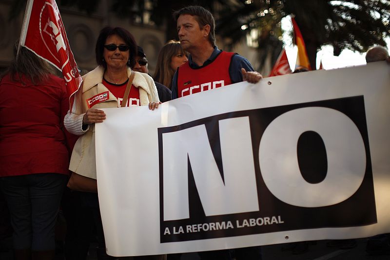 Members of the union CCOO hold a banner during a protest against labour reform of the Spanish government in Malaga