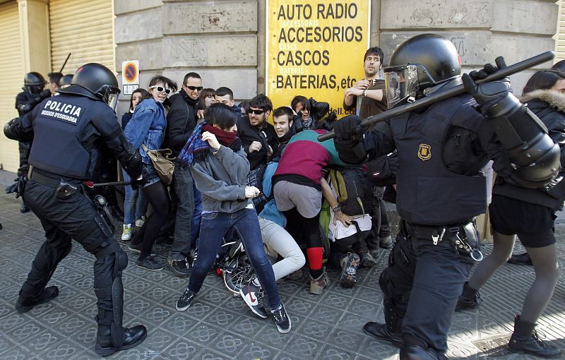 Police disperse demonstrators during protests against spending cuts in public education in Barcelona